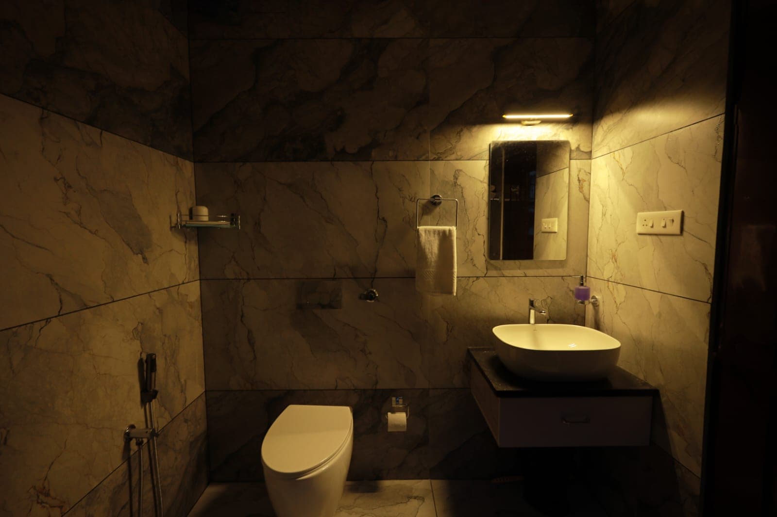 Warm-lit marble bathroom