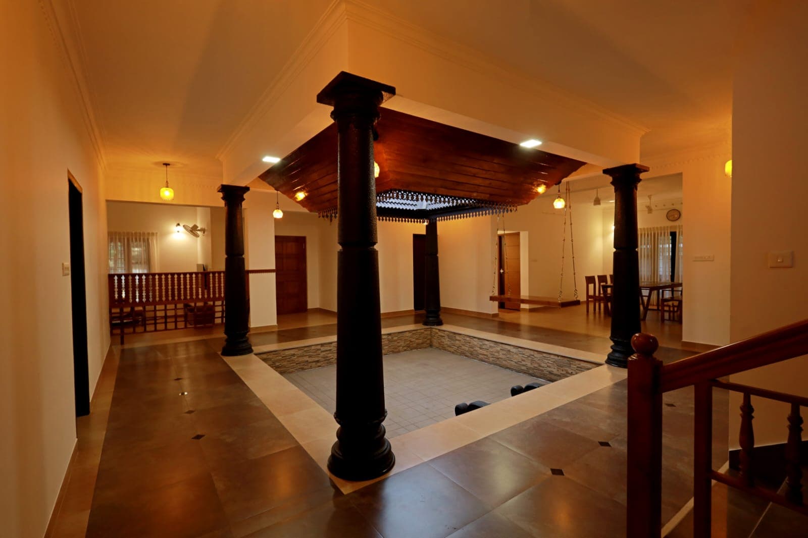 Carved timber pillars around the sunken courtyard