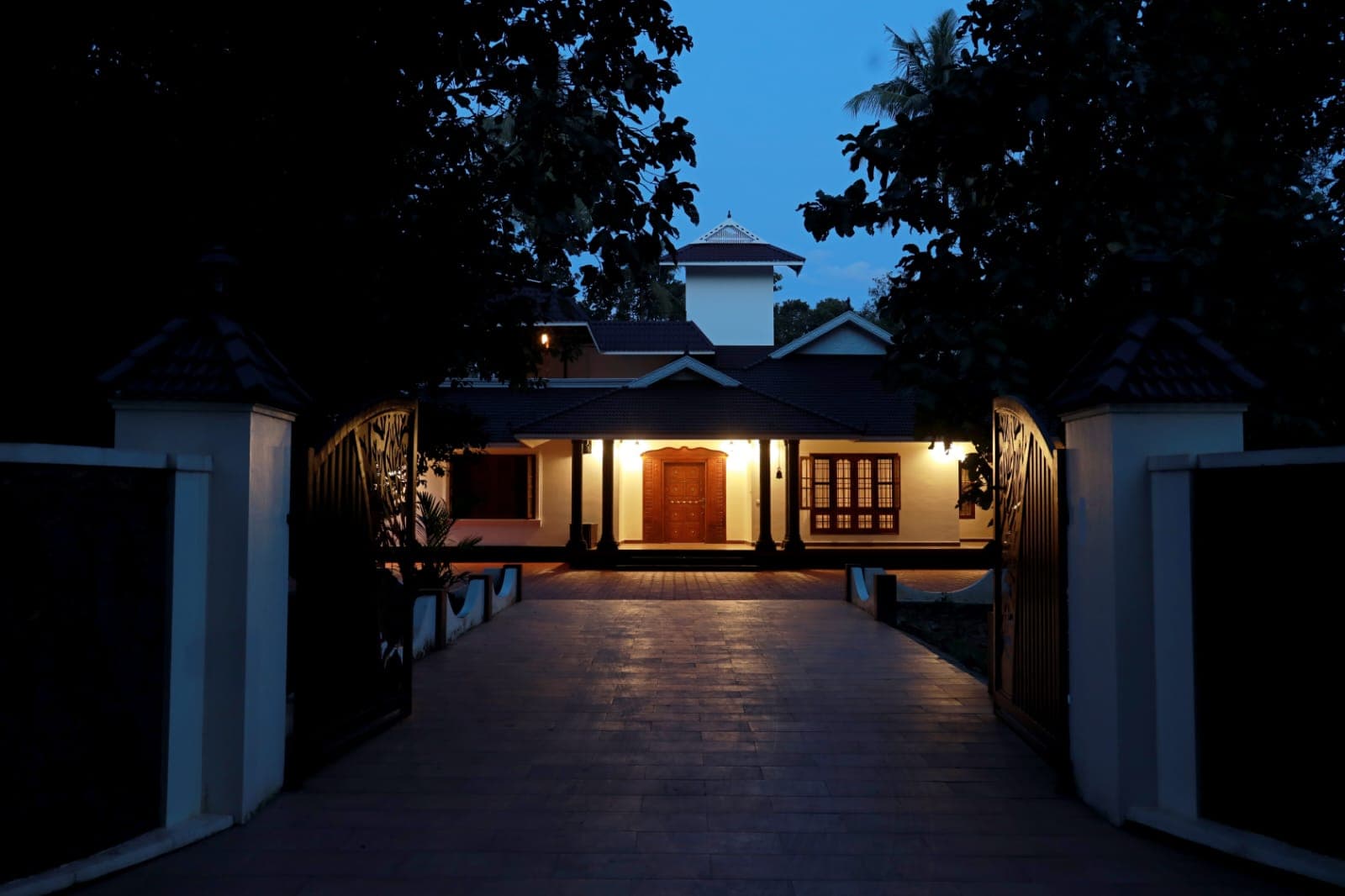The lit portico and gate at blue hour