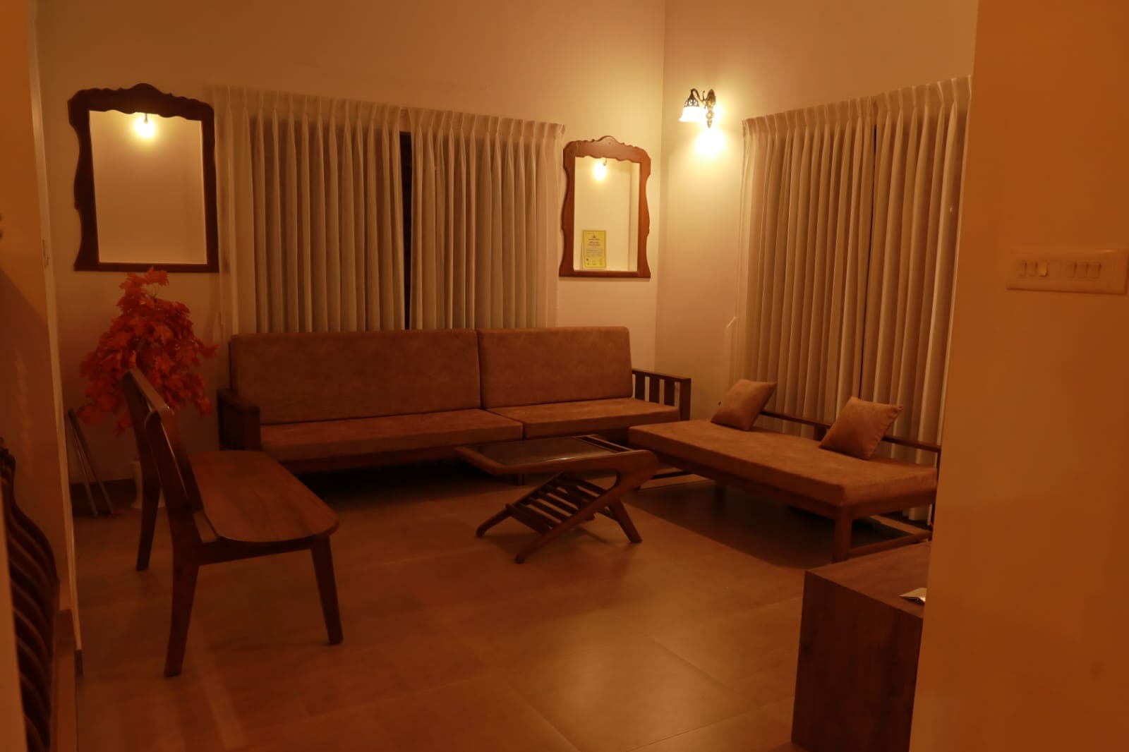 Living room with timber sofas and mirrors