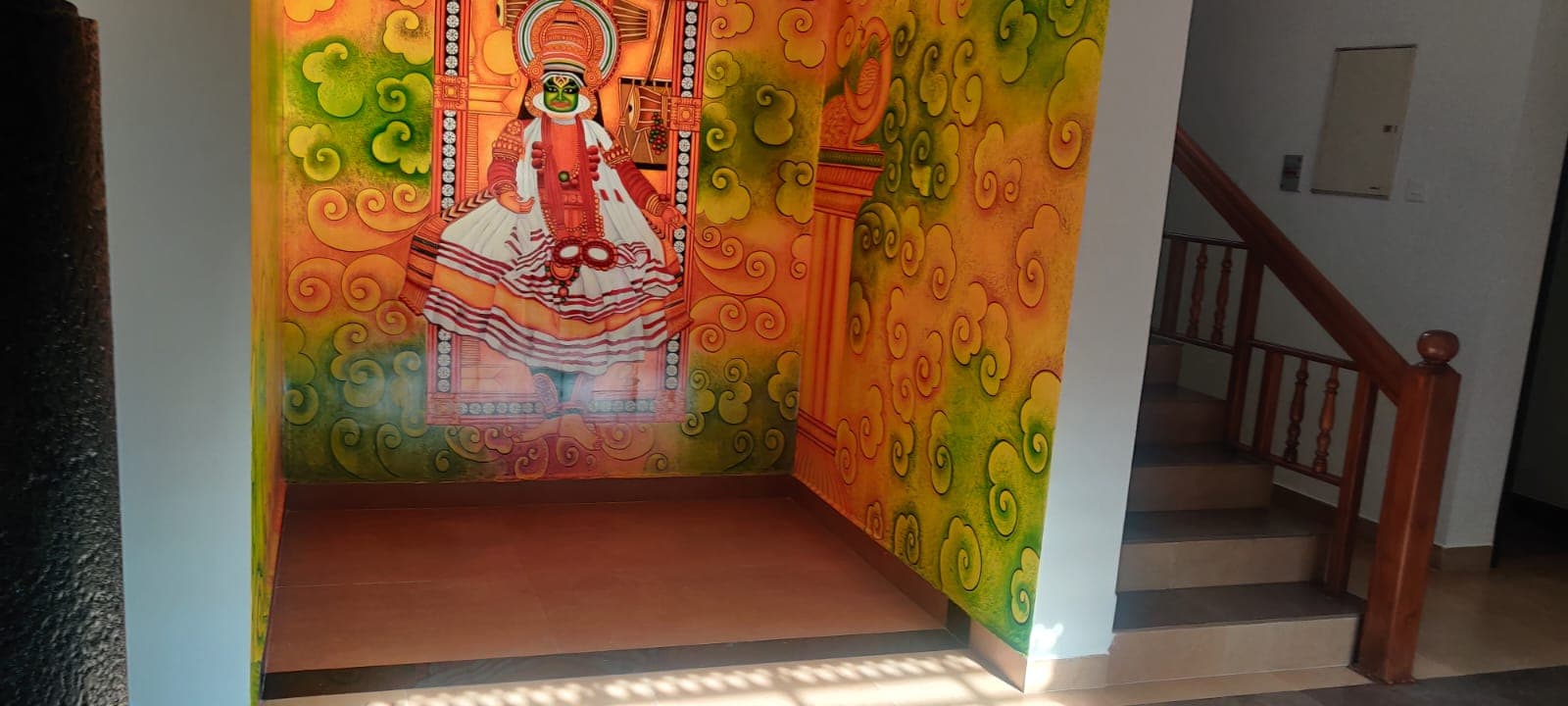 Hand-painted Kathakali mural beside the staircase