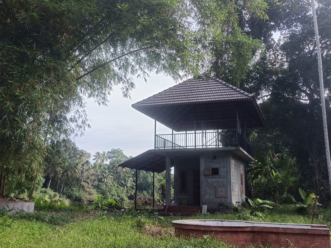 Two-storey riverside pavilion among bamboo