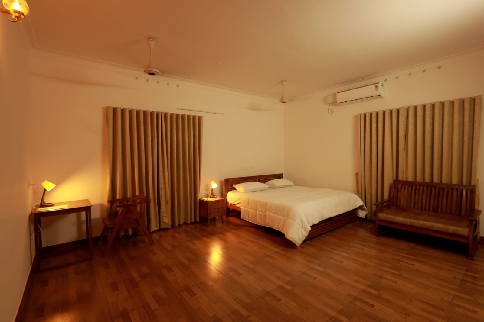 The Nutmeg Suite with a king bed, writing desk and timber bench