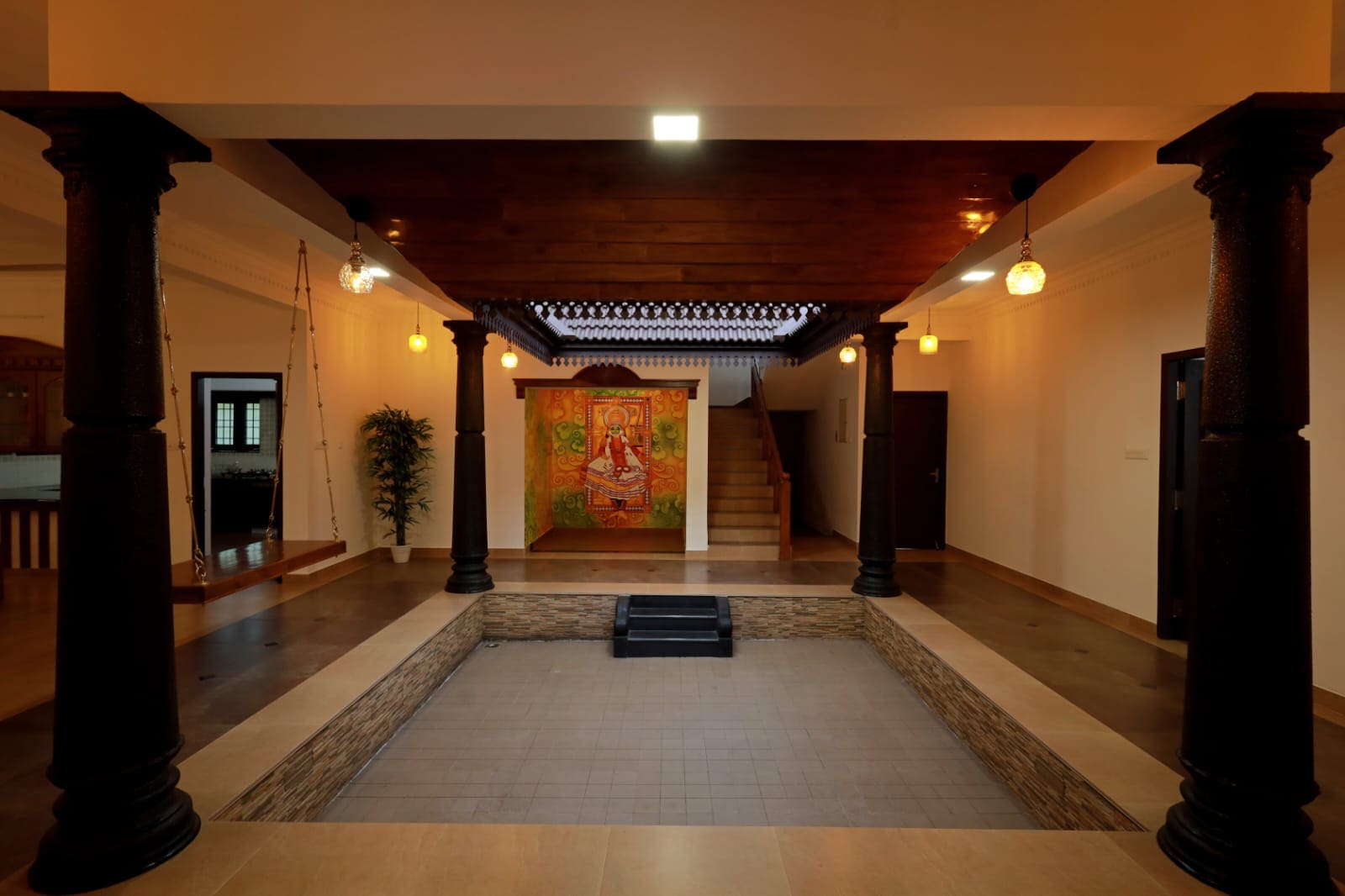Pillared nalukettu courtyard with a carved timber ceiling and mural